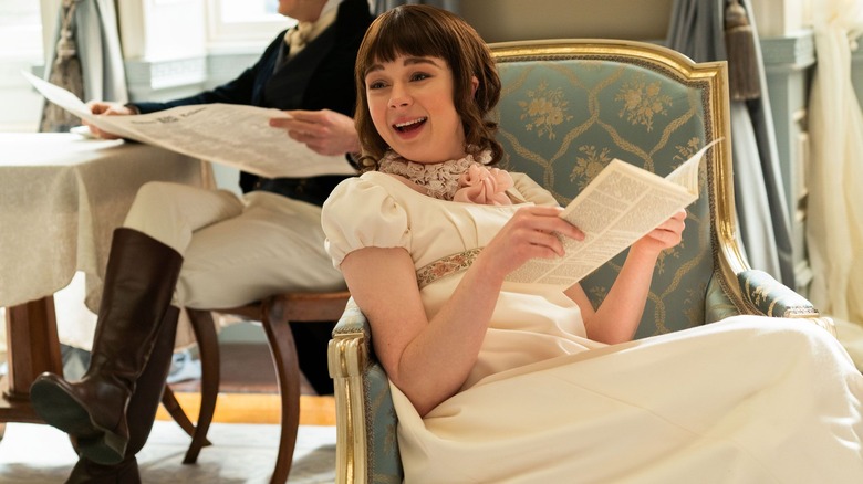 Eloise Bridgerton laughing and reading in a chair