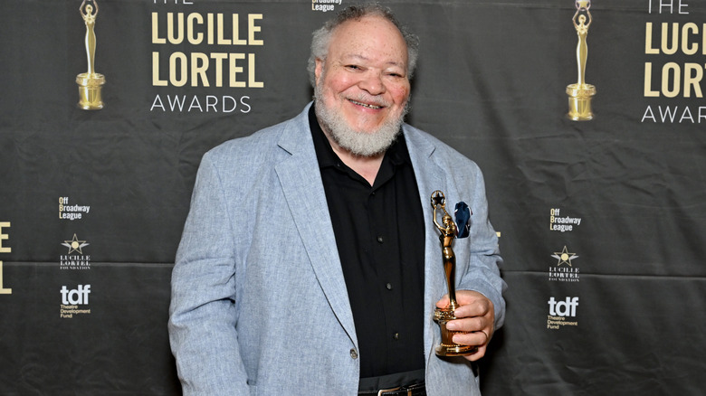 Stephen McKinley Henderson holding trophy