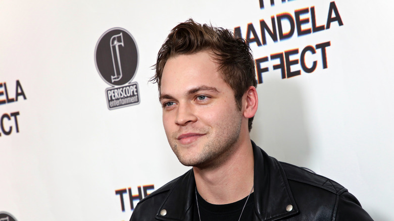 Alexander Calvert smiles