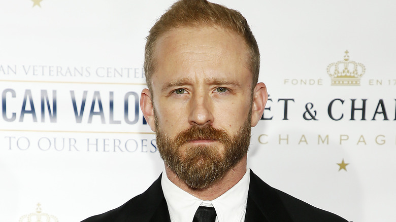 Ben Foster in a suit and tie with beard