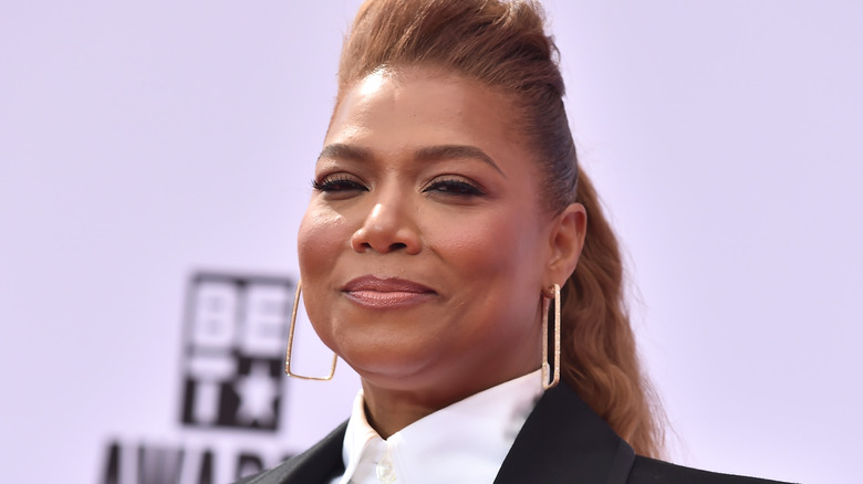 Queen Latifah with an updo and white shirt