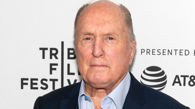 Robert Duvall in a blue shirt and suit