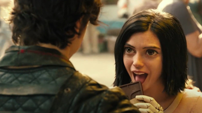 Alita eating a chocolate bar in Alita: Battle Angel