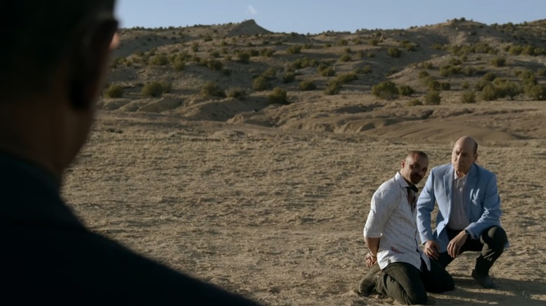 Nacho on knees in desert