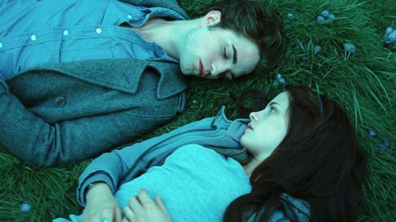 Bella Swan and Edward Cullen lying in grass