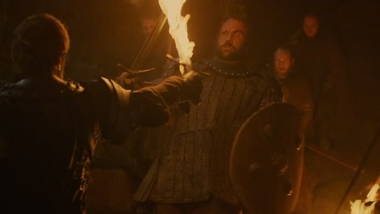 Hound backing away from a flaming sword