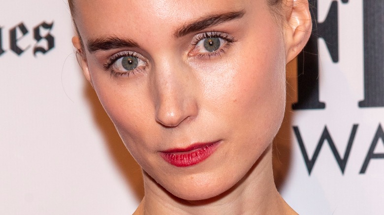 Rooney Mara looks forward in red lipstick 