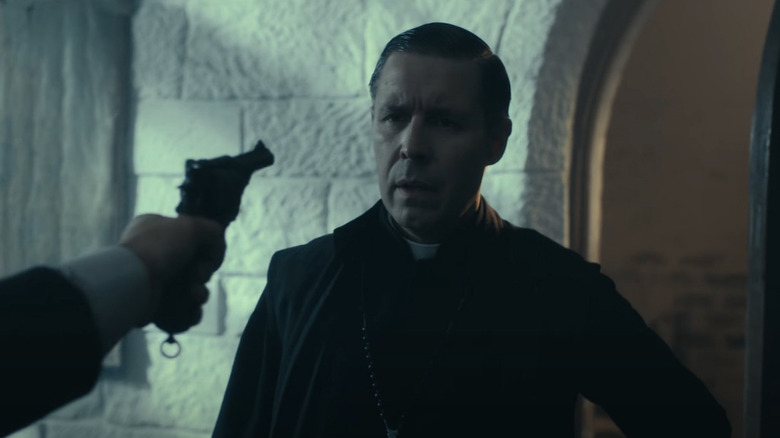 Gun pointing as Father John Hughes