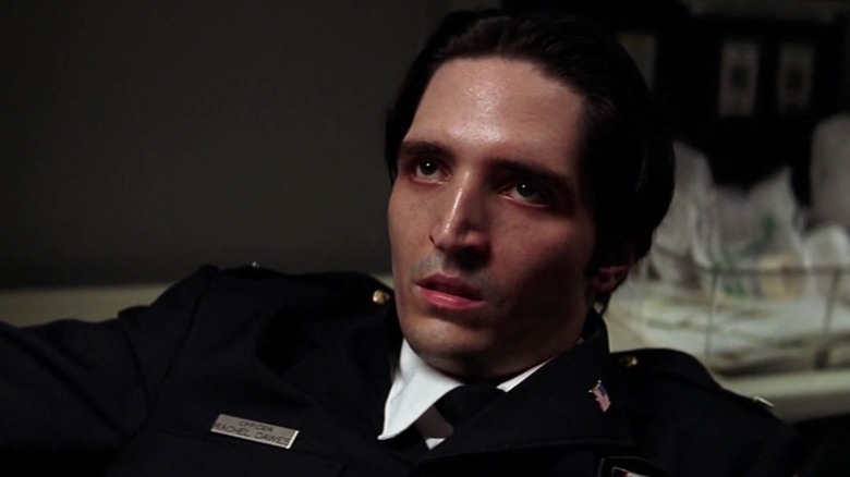 David Dastmalchian in "The Dark Knight" looking up