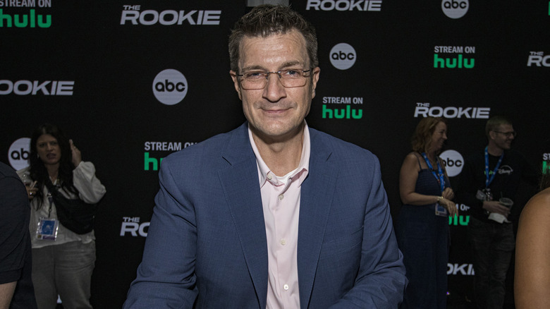 Nathan Fillion smiles at an event for "The Rookie"