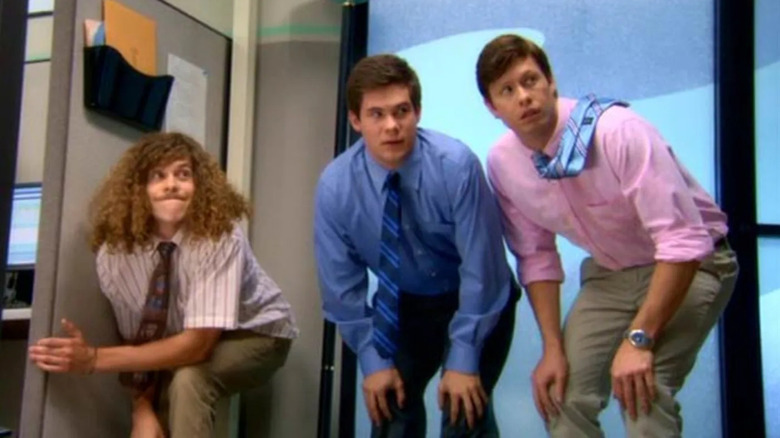 Anders, Blake, and Adam crouch in the office