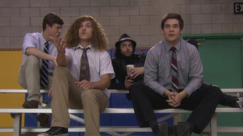 Anders, Blake, and Adam sit on bleachers