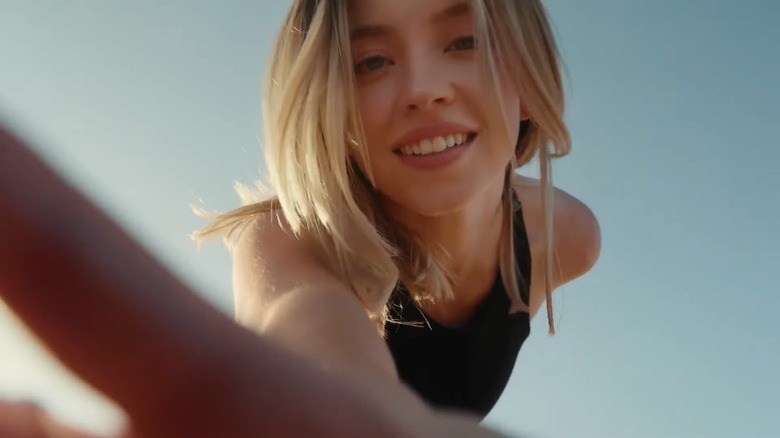 Sydney Sweeney smiling grabbing camera