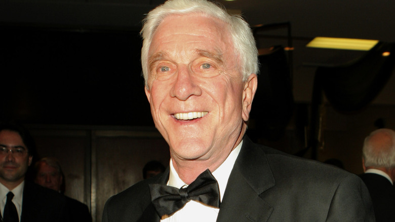 Leslie Nielsen smiling in a suit