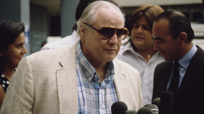 Marlon Brando in sunglasses in front of microphones