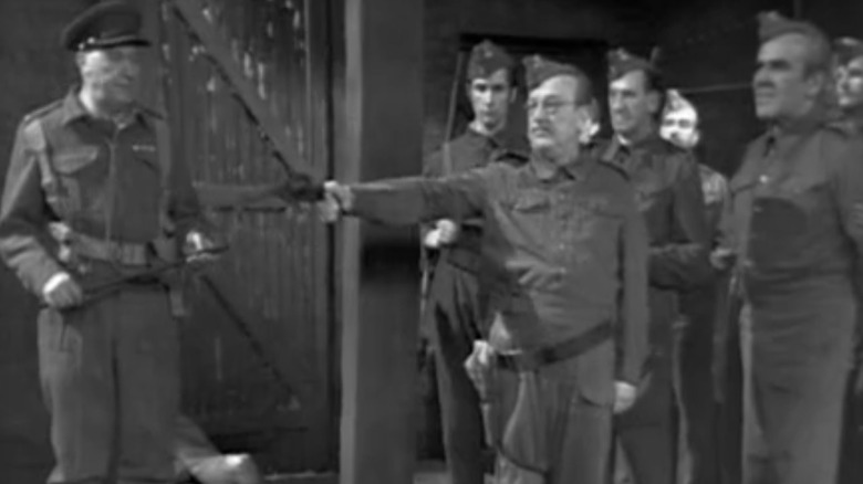 Mainwaring raises a pistol