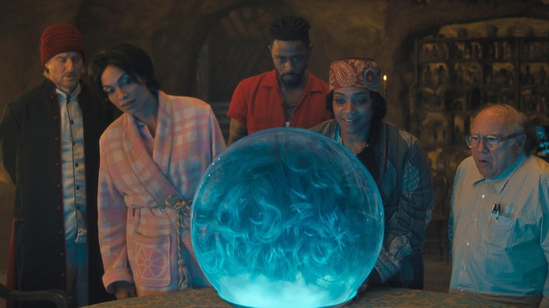 Gabbie, Ben, and others inspect glowing orb