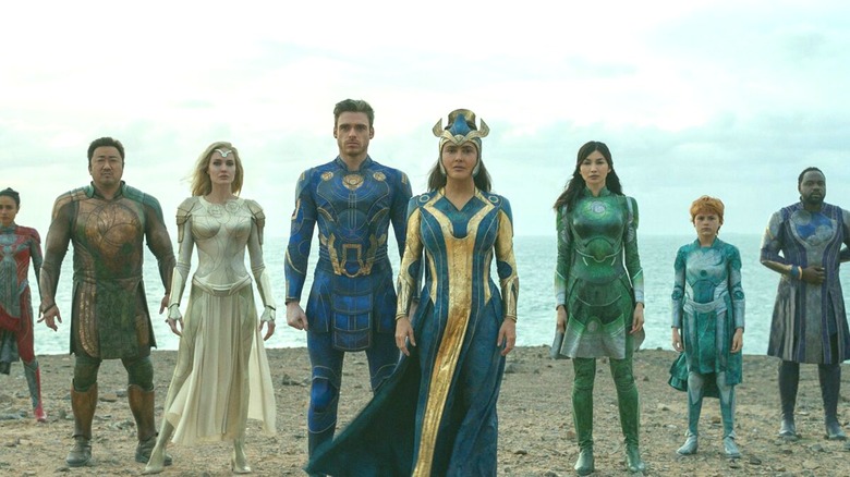 The Eternals standing on beach