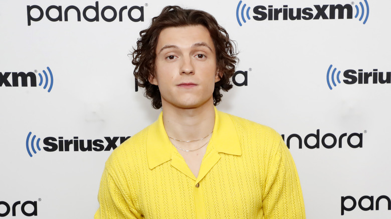 Tom Holland wearing yellow shirt