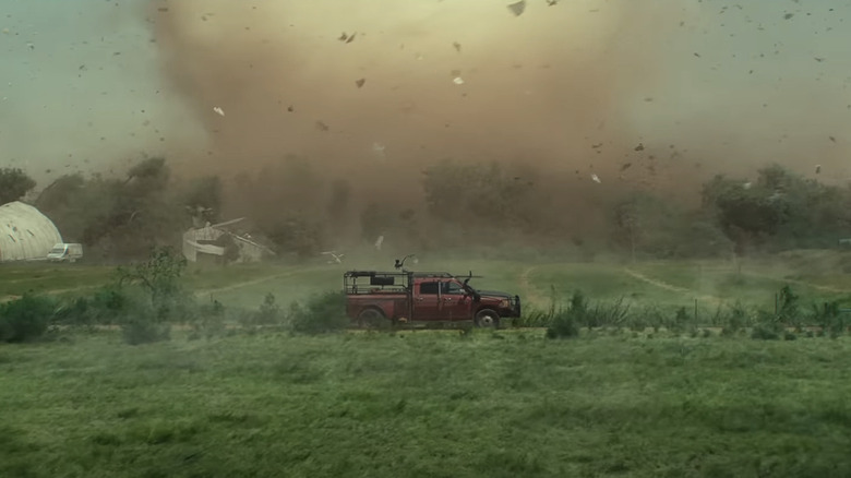 Tornado approaches red truck