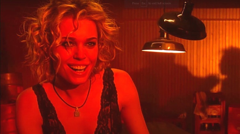 Laure grinning in red light