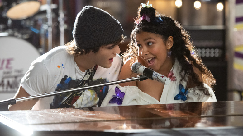 Luke and Julie sing at the piano