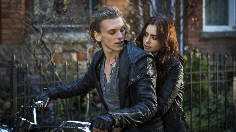 Clary and Jace sitting on motorcycle 