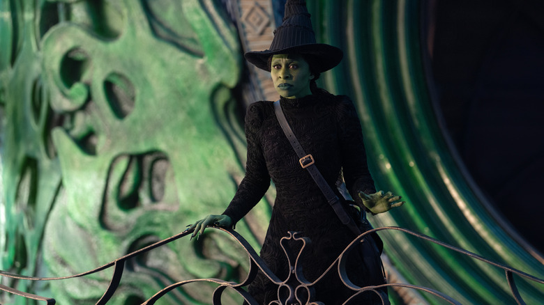 Elphaba looking over a railing at the Wizard's castle in Oz in Wicked