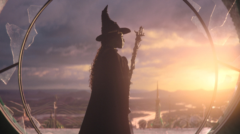 Elphaba with her broom looking out at Oz in Wicked