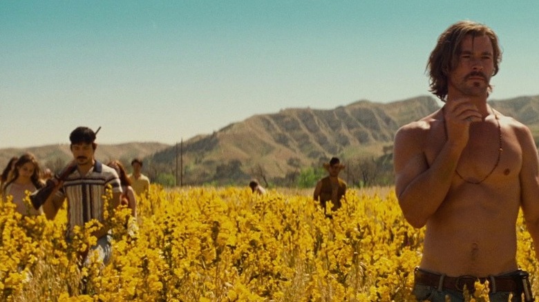 Chris Hemsworth shirtless in a field of flowers