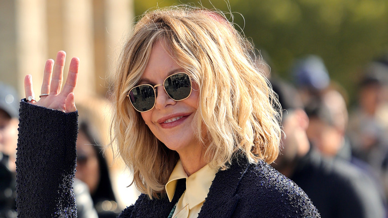 Meg Ryan waves at a summer 2024 fashion event