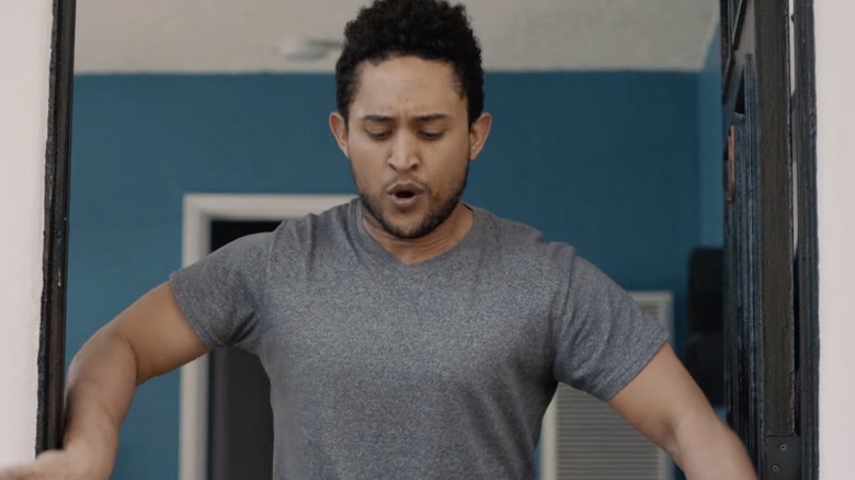 Tahj Mowry holding a doorway