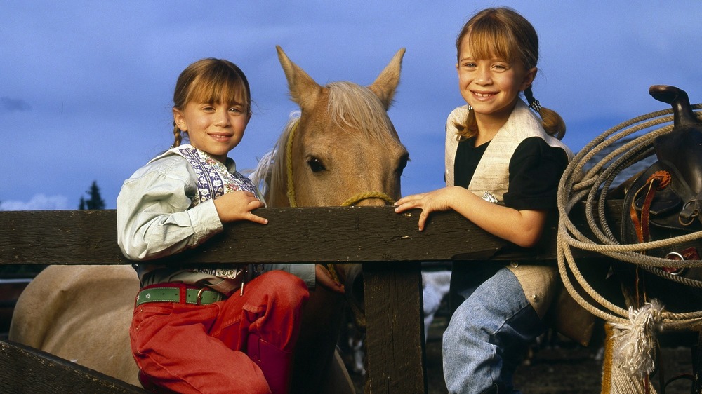 Mary-Kate and Ashley Olsen pose with horses for Disney TV movie How the West Was Fun