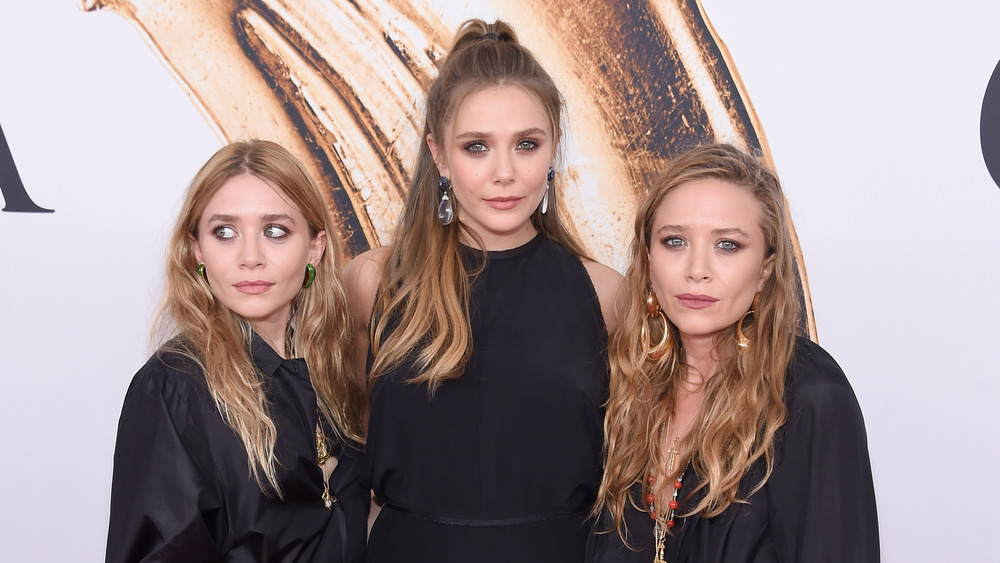 Mary-Kate, Ashley, and Elizabeth Olsen at an event