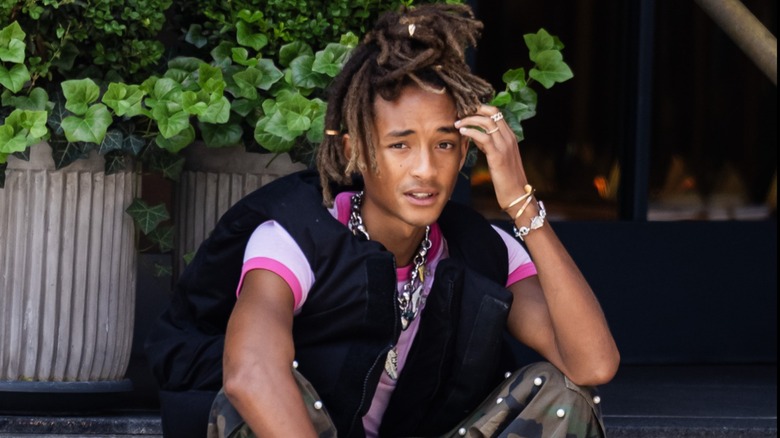 Jaden Smith sits outside on steps in Tribeca