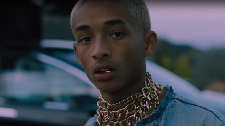 Jaden Smith standing in front of a car