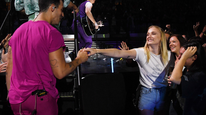 Turner touching Jonas at a concert