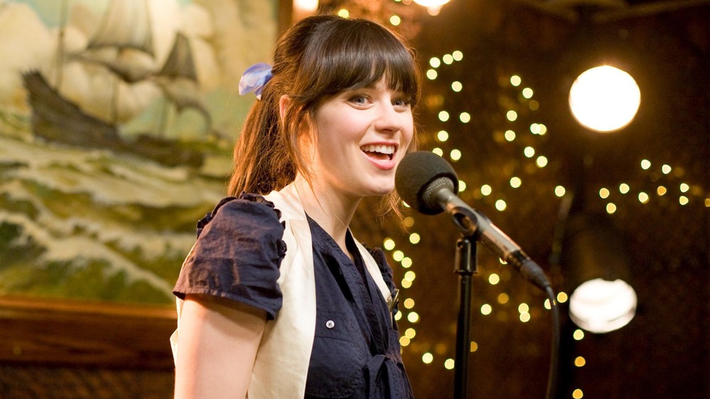 Zooey Deschanel at a microphone