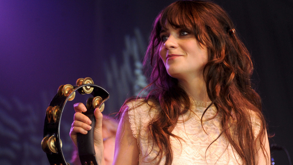 Zooey Deschanel shaking a cymbal