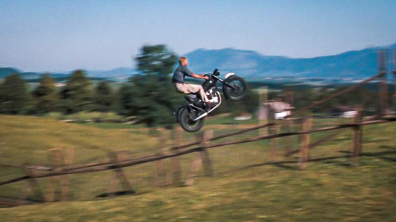 Bud Ekins rides a motorcycle