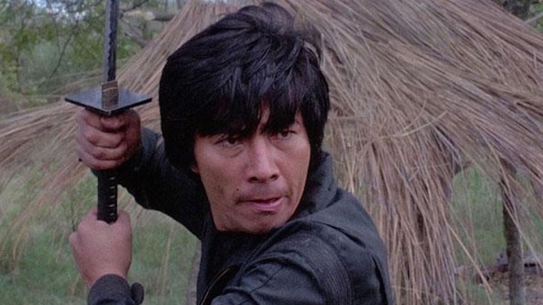 Sho Kosugi holds a sword