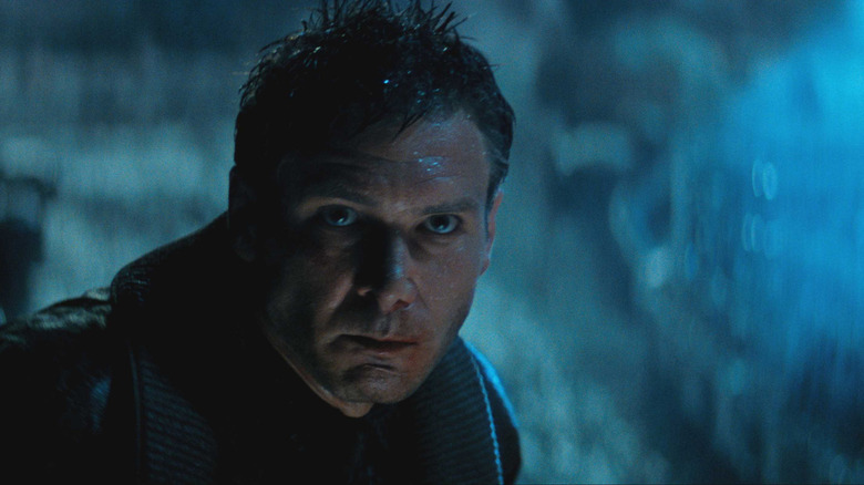 Rick Deckard looks up in the rain