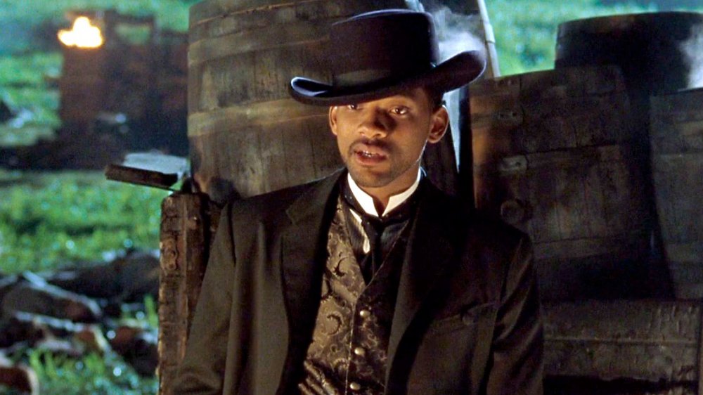 Will Smith stands in front of barrels dressed in cowboy gear as Captain James West in Wild Wild West