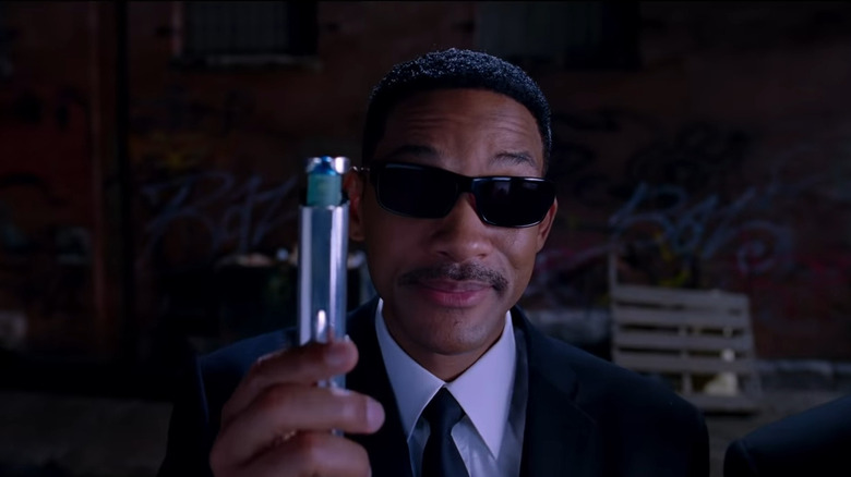 Will Smith holds neuralizer Men In Black 3