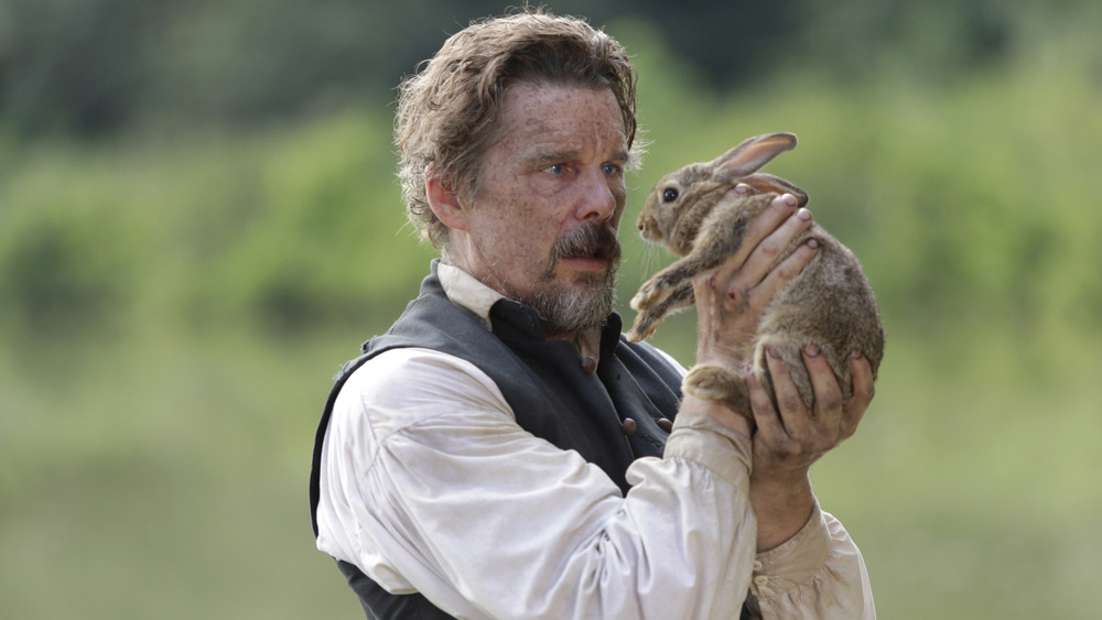 Ethan Hawke's John Brown holds a rabbit on The Good Lord Bird