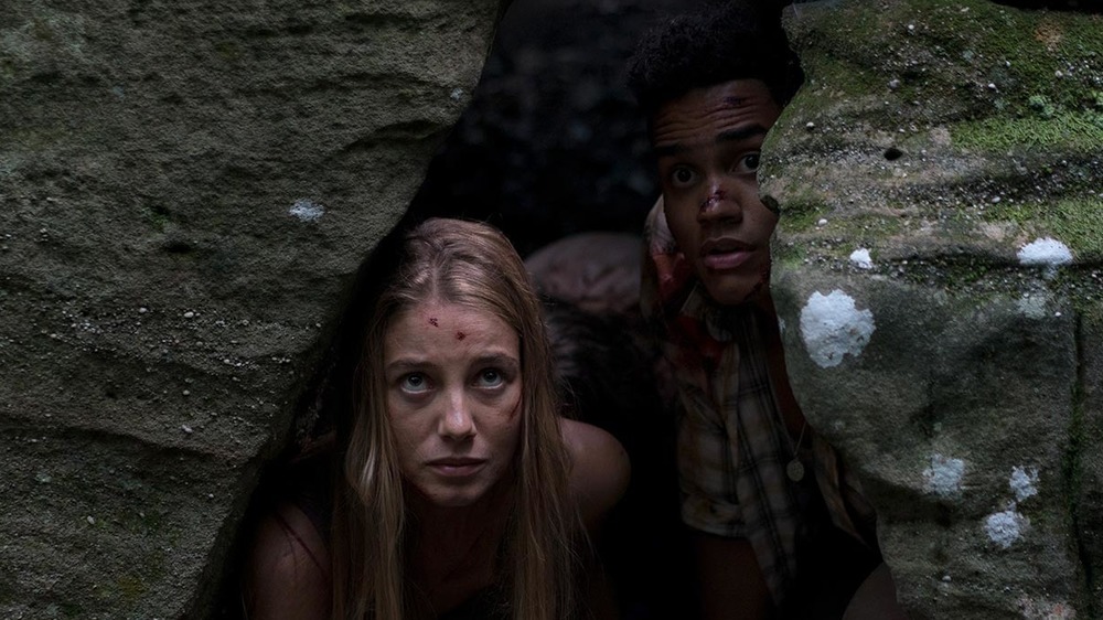 Jen and Darius hiding in a cave
