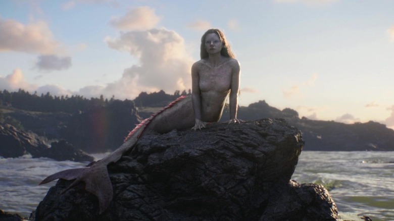 Siren Ryn sitting on rock