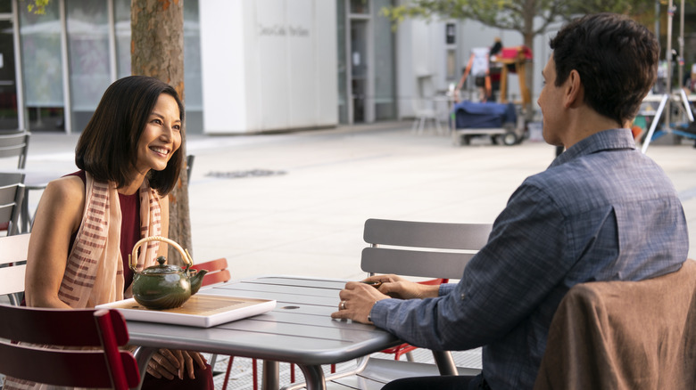 Kumiko and LaRusso sitting at a table