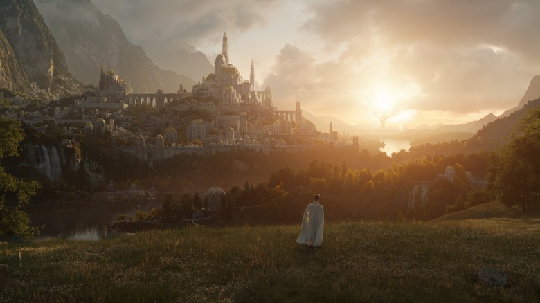 Man on hill looking at city on Amazon's Lord of the Rings