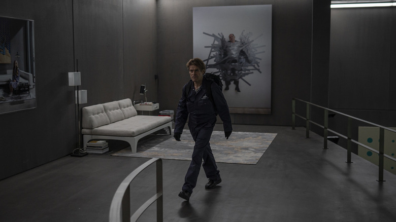 Willem Dafoe as Nemo walking through chic room